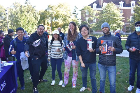 Students pose with door prizes outside at the 150th Anniversary of the Mathematics Department Celebration, at Homecoming 2023